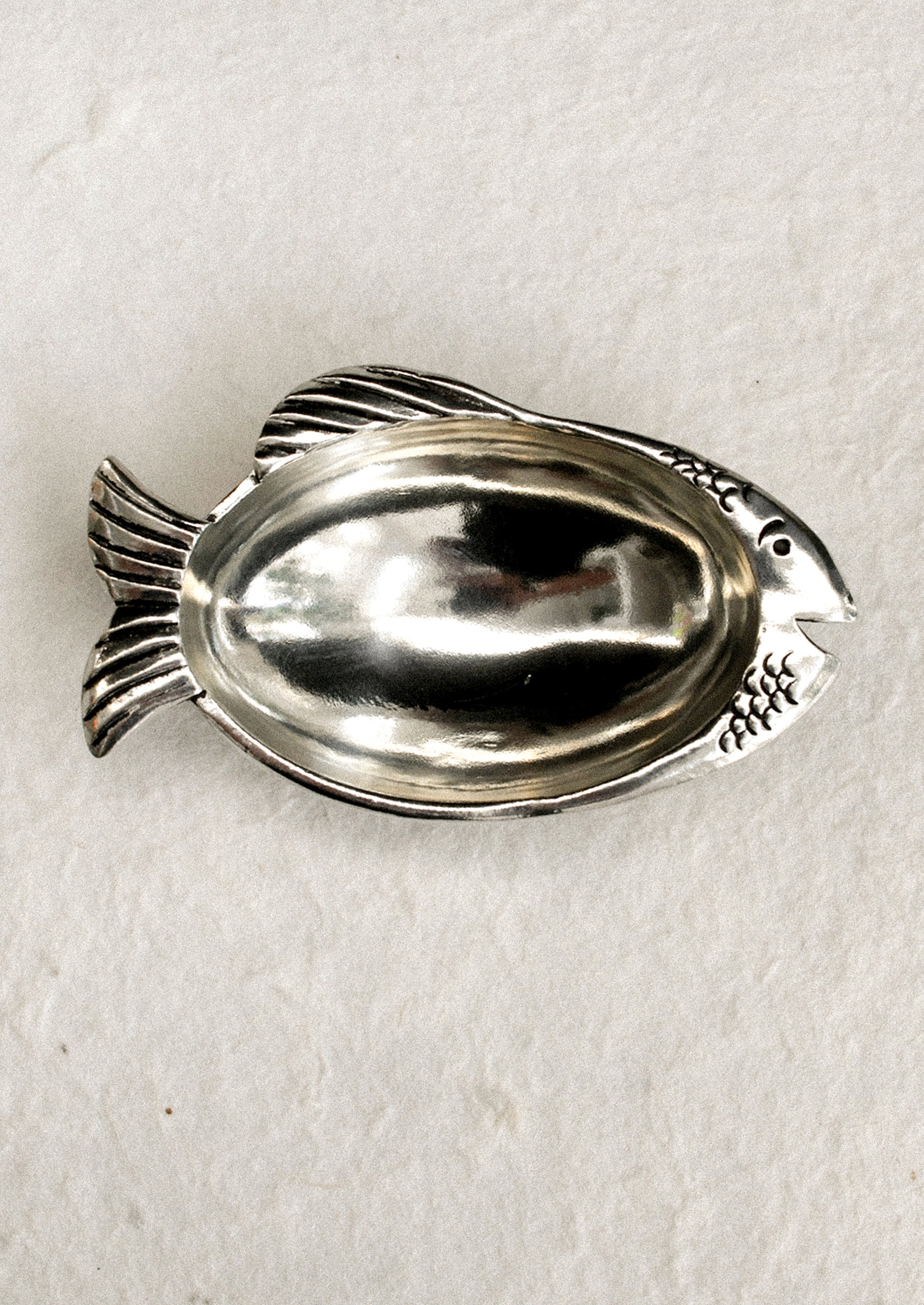 A silver fish shaped dish.