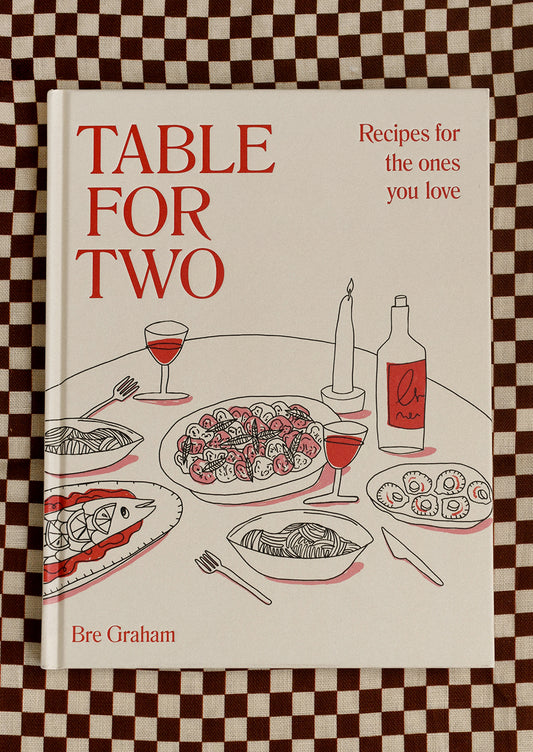 Cookbook titled 'Table for Two' on a checkered background