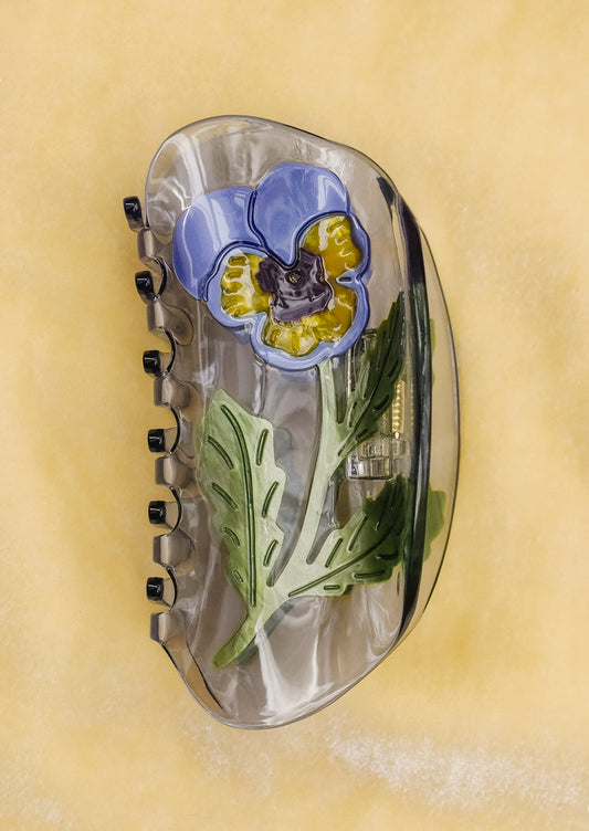 A transparent hair claw with pansy motif.