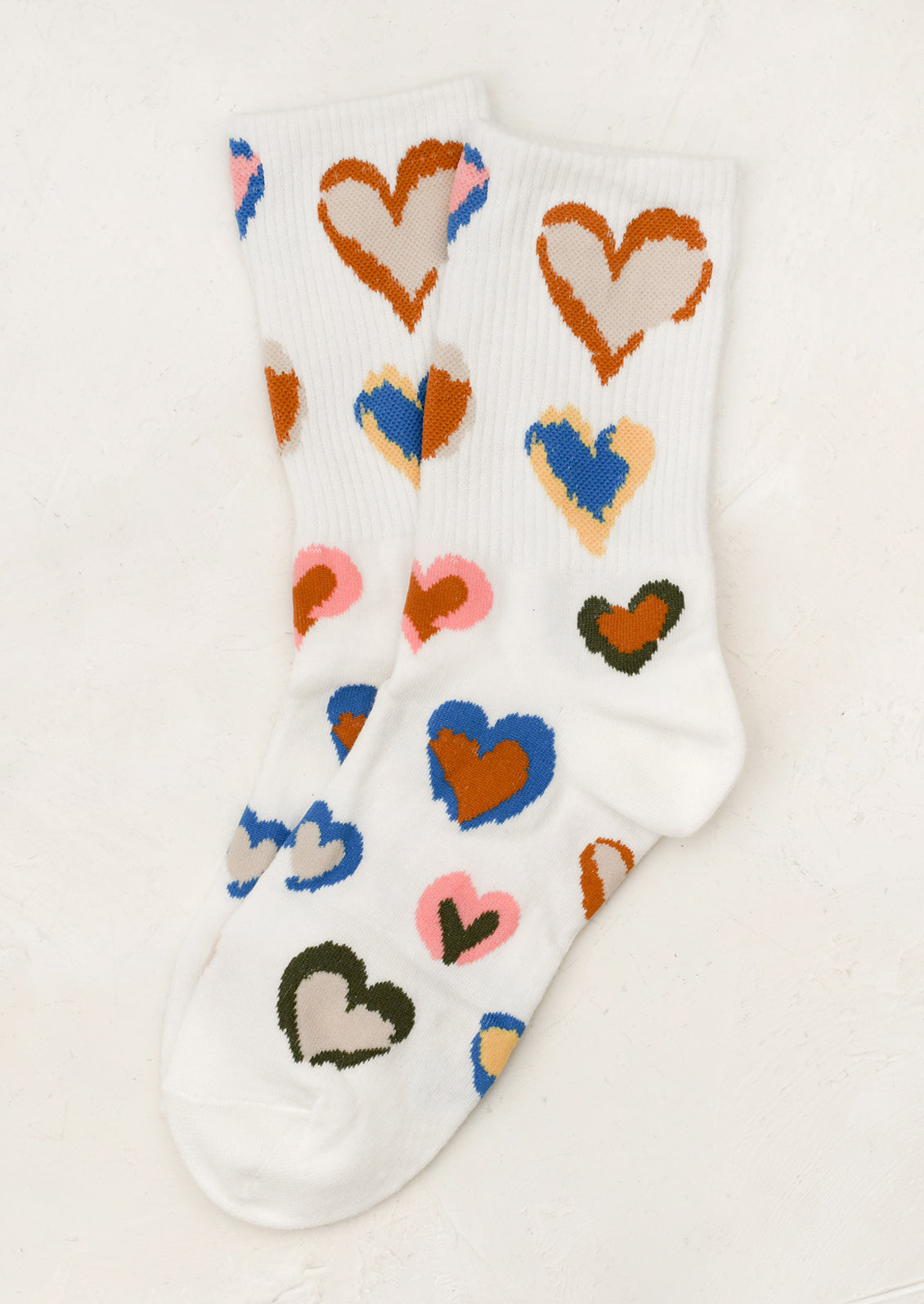 White socks with colorful heart patterns on a white background