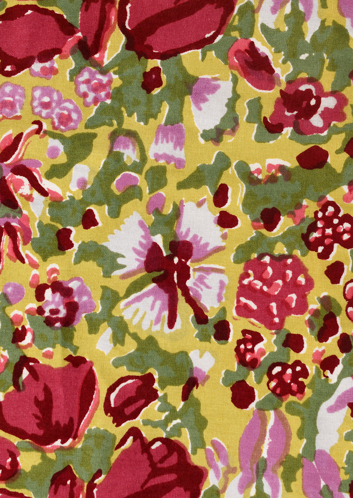 A pair of napkins in green block printed floral pattern.