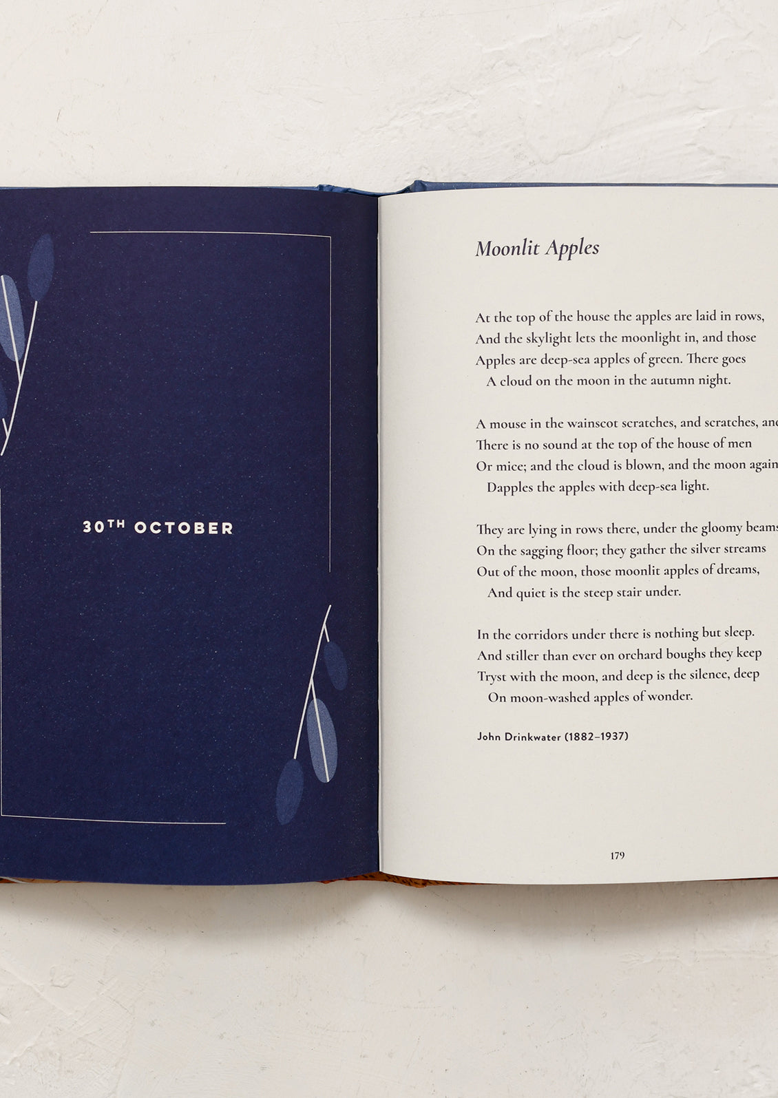 Open book with a poem titled 'Moonlit Apples' on a white background