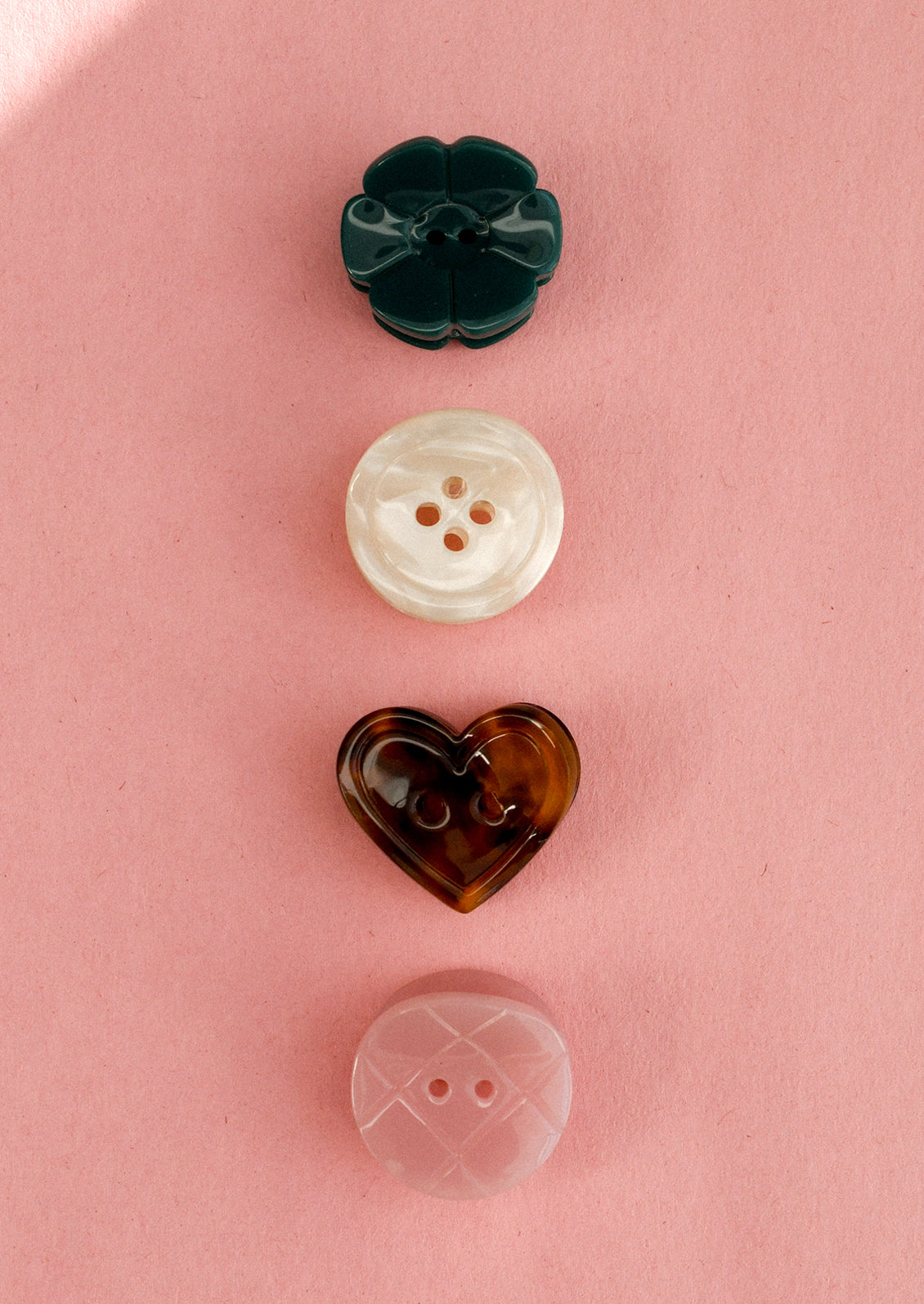 A set of four assorted mini hair claws that look like buttons.