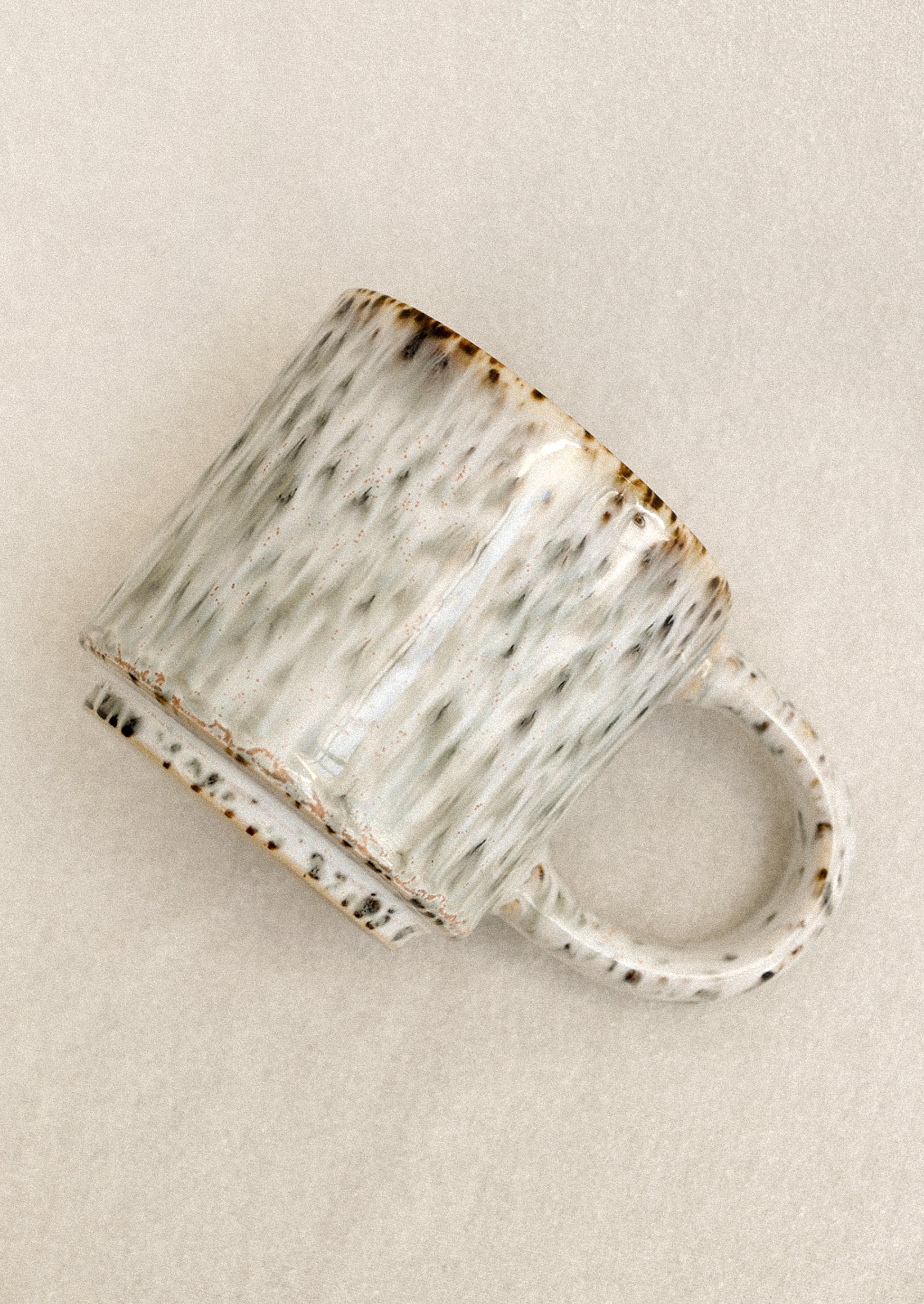 Ceramic mug with textured surface on a beige background