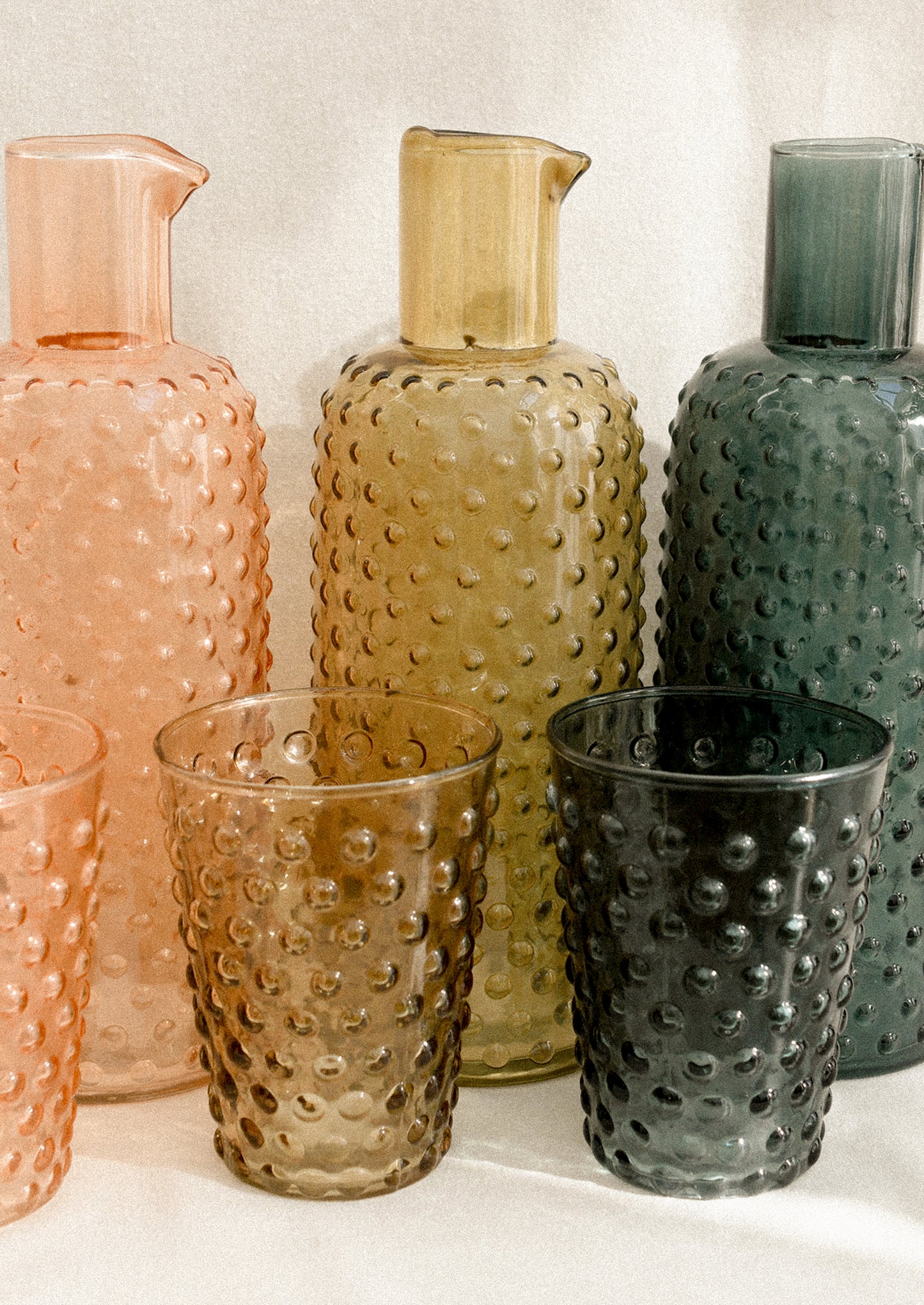 Hobnail glass carafes in three color options.
