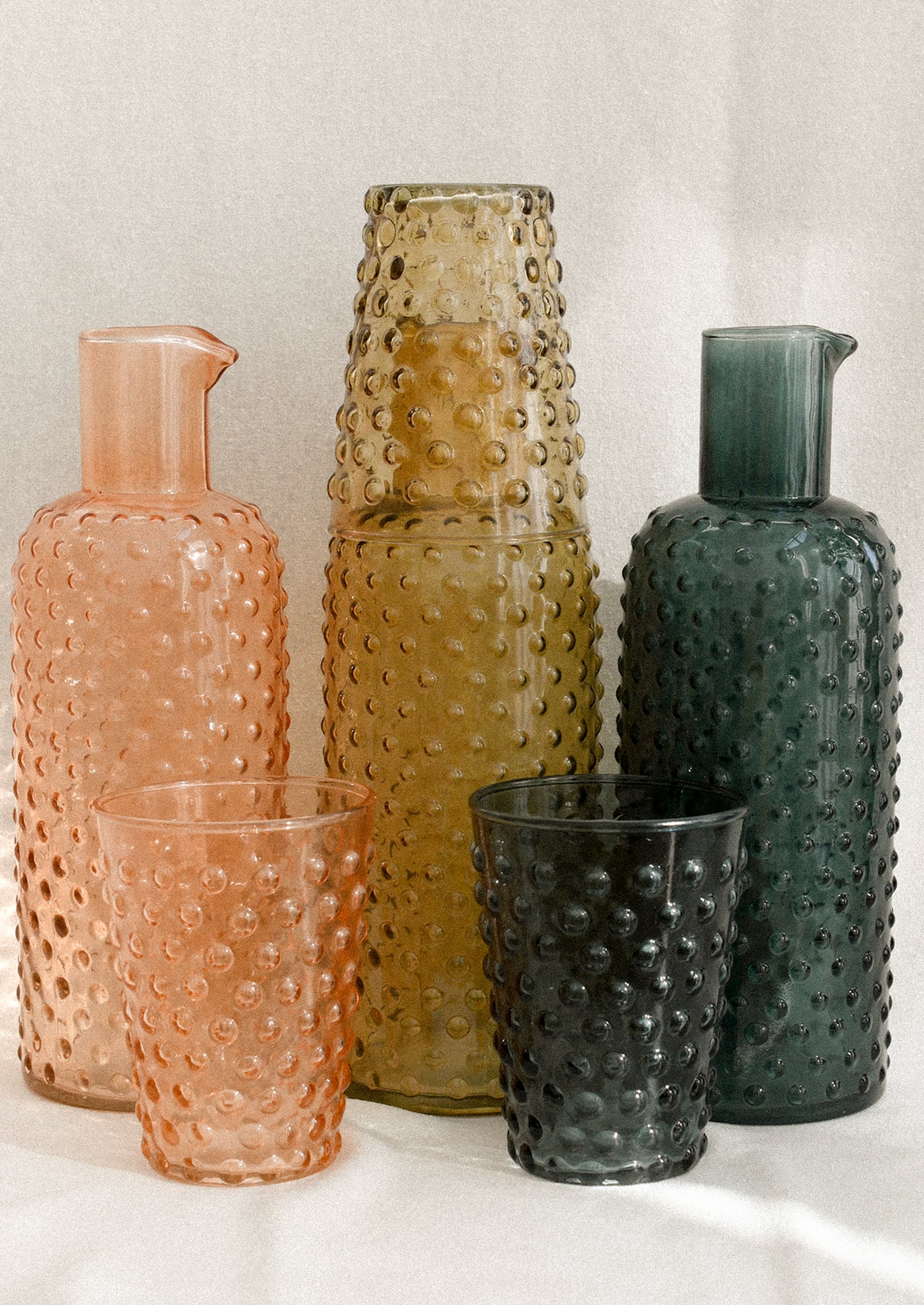 Hobnail glass carafes in three color options.
