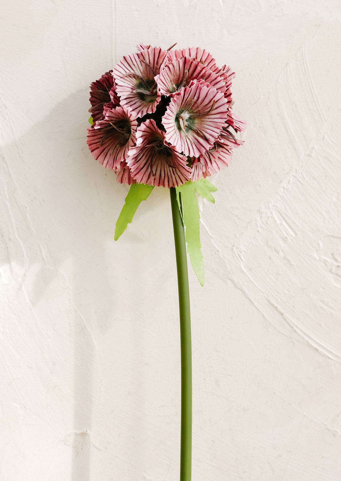 Pink artificial flower on a white background