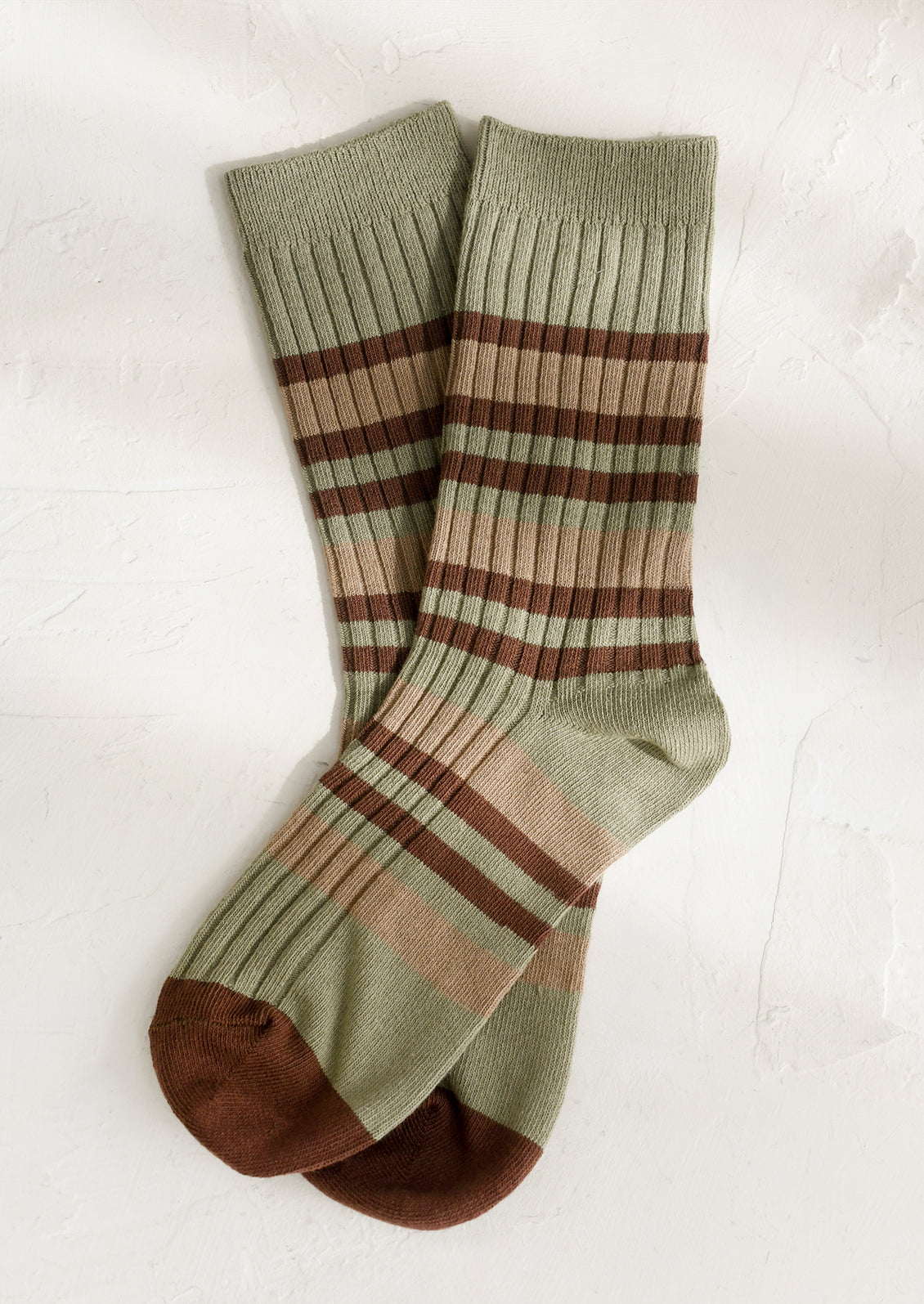 A pair of striped socks in dusty green and brown stripe.