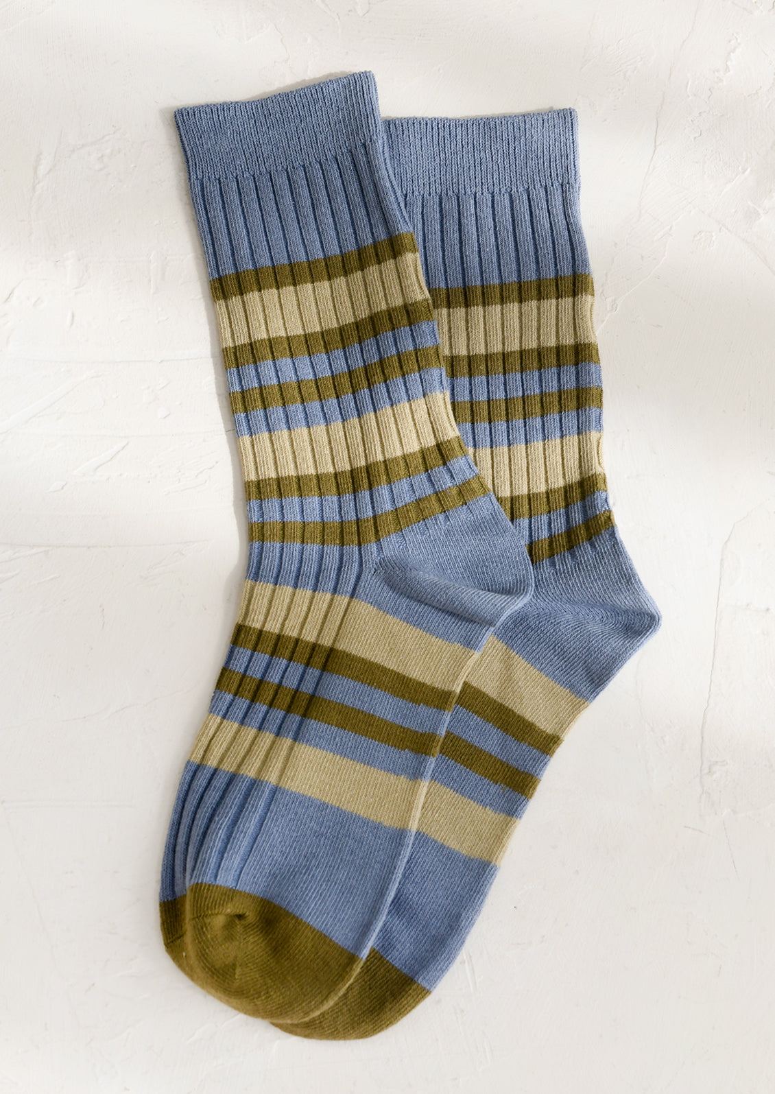 A pair of striped socks in dusty blue and green stripe.
