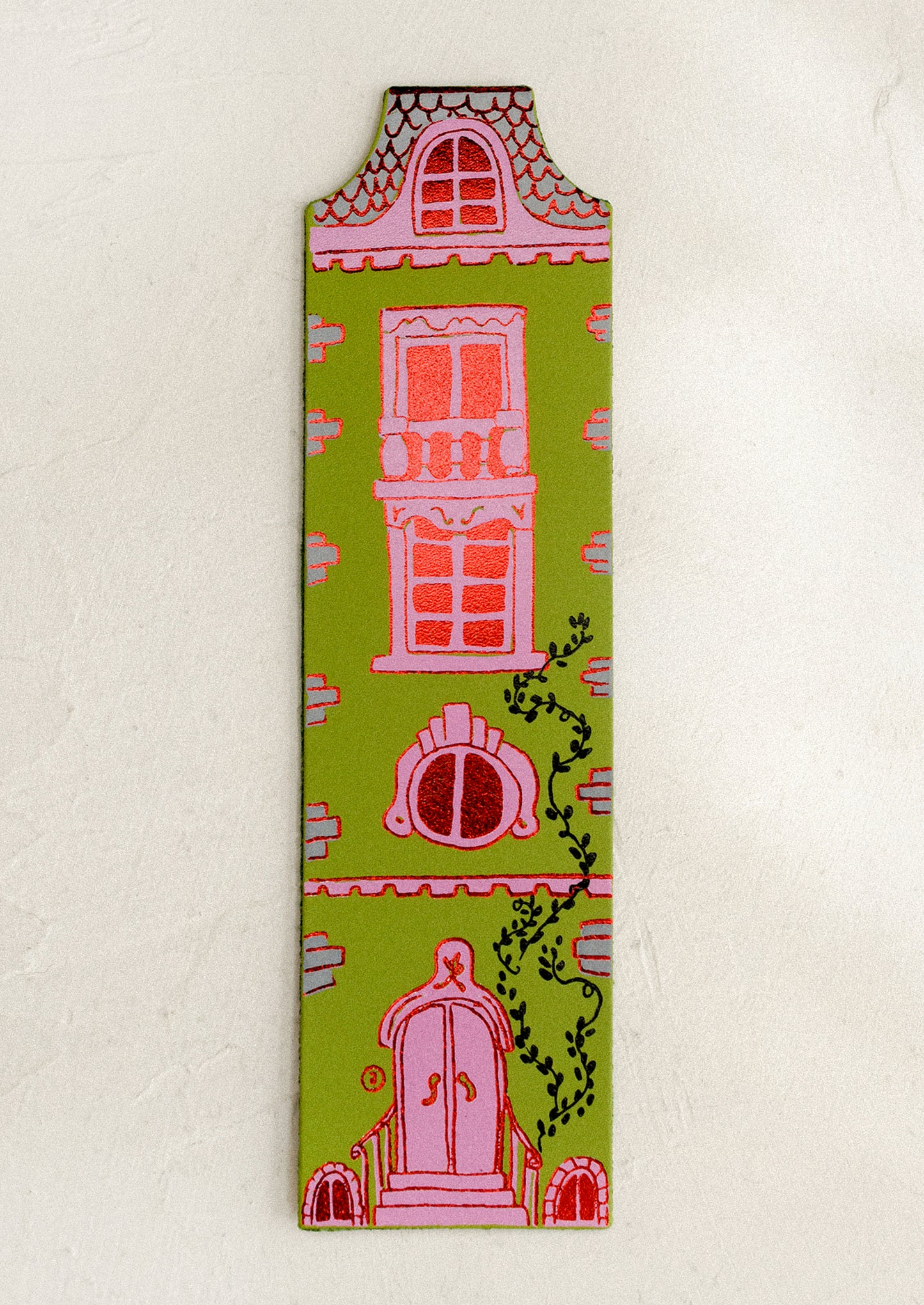 Decorative doll-house shaped bookmark with architectural illustrations on a beige background