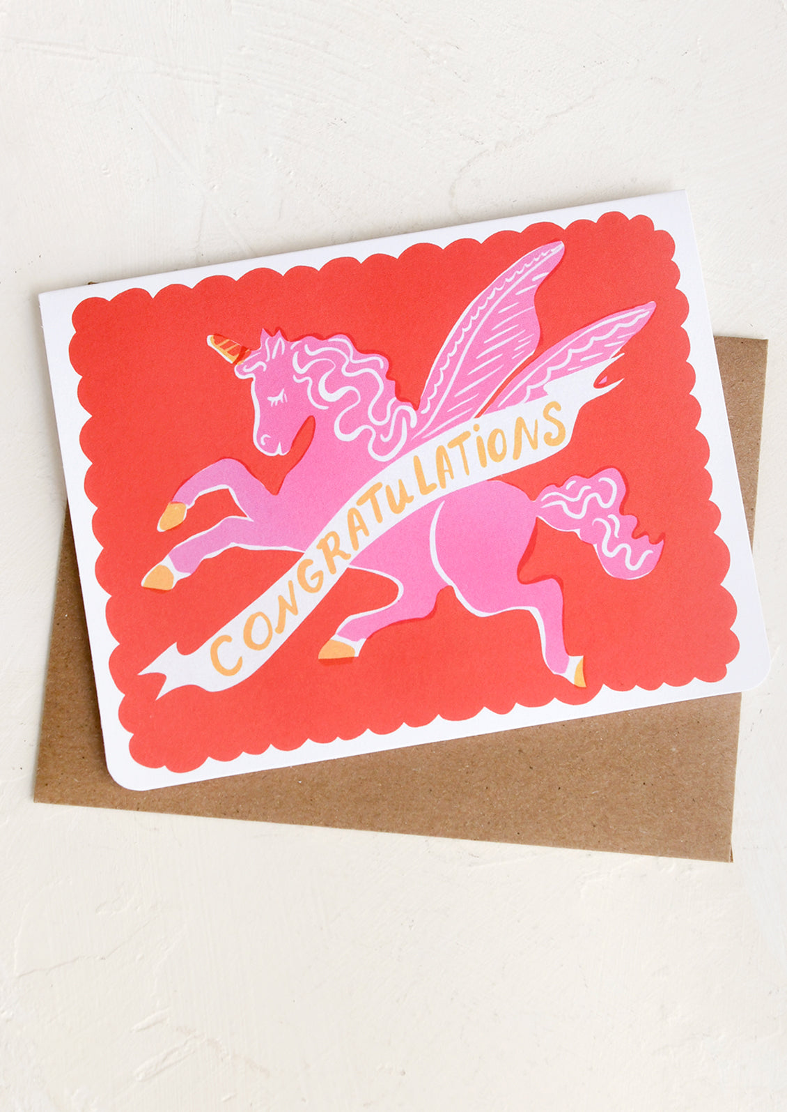 Greeting card with pink pegasus design and 'Congratulations' text on a white background