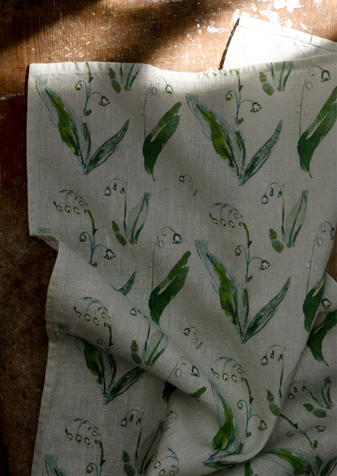 Kitchen tea towel with green lily of the valley pattern