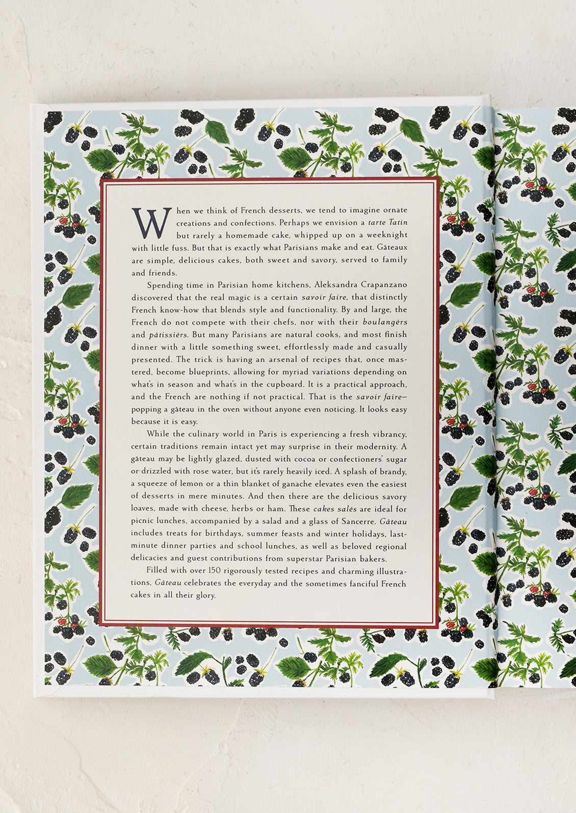 Book with a decorative cover featuring greenery and text on a white background