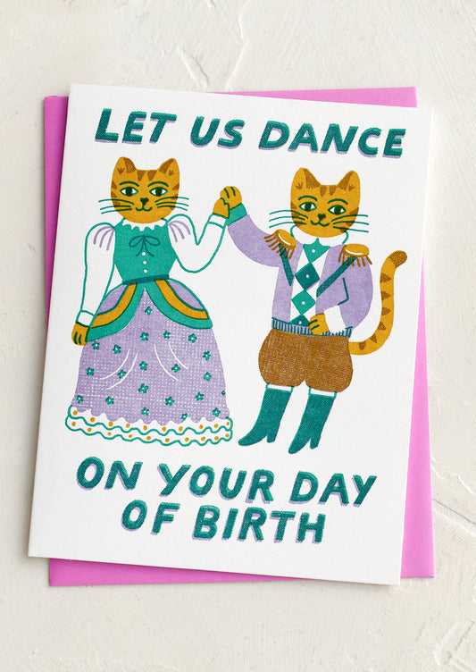 Greeting card with dancing cats and text 'Let Us Dance On Your Day of Birth' on a white background.