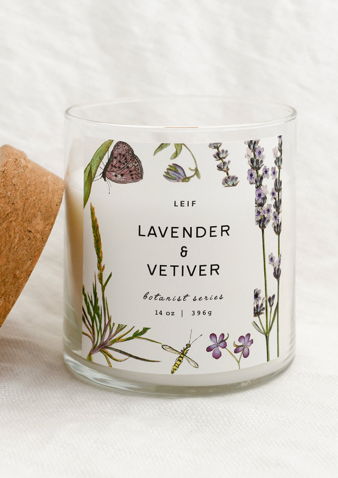 Candle with lavender and vetiver label on a white background