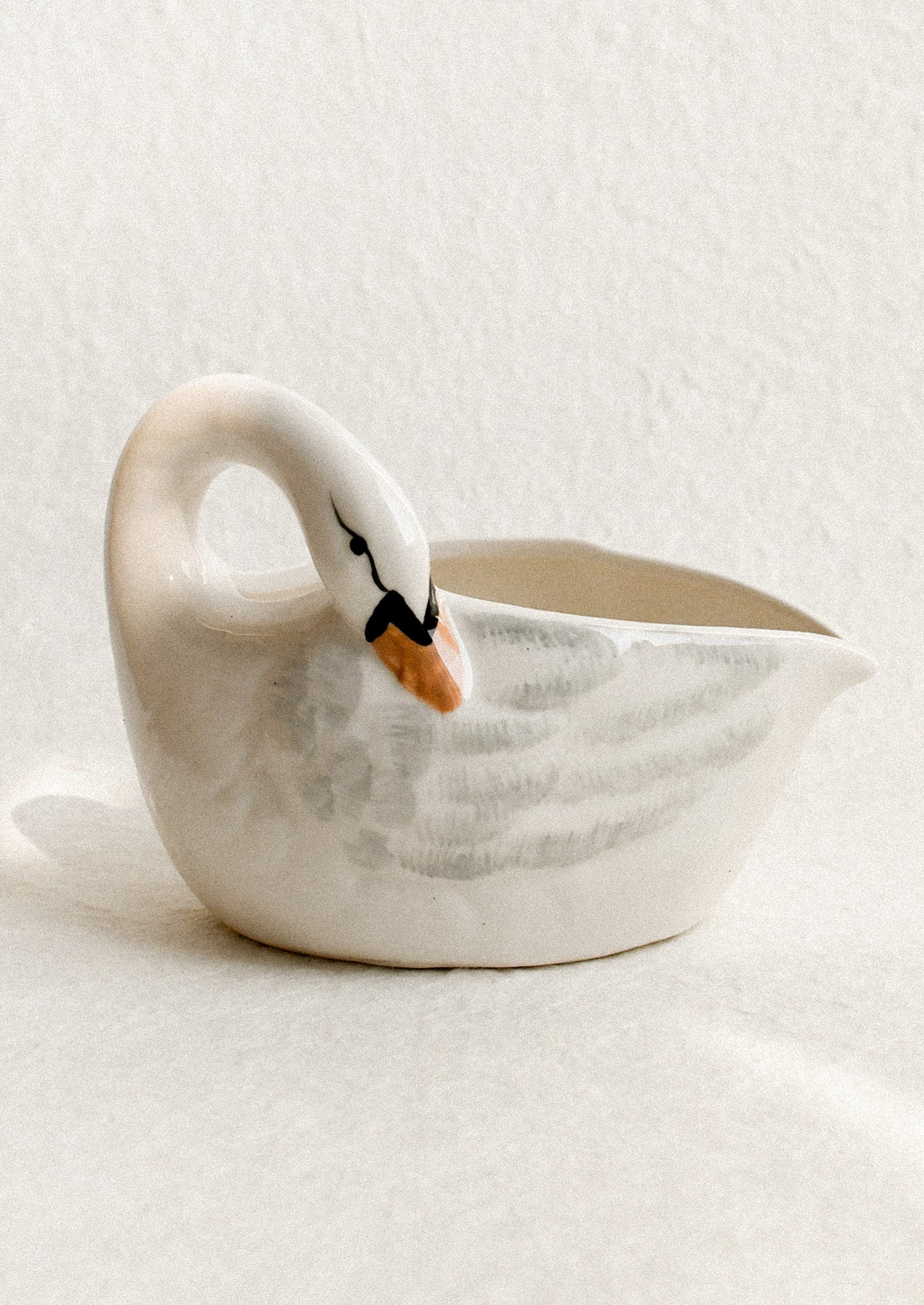 Ceramic swan-shaped bowl on a light background