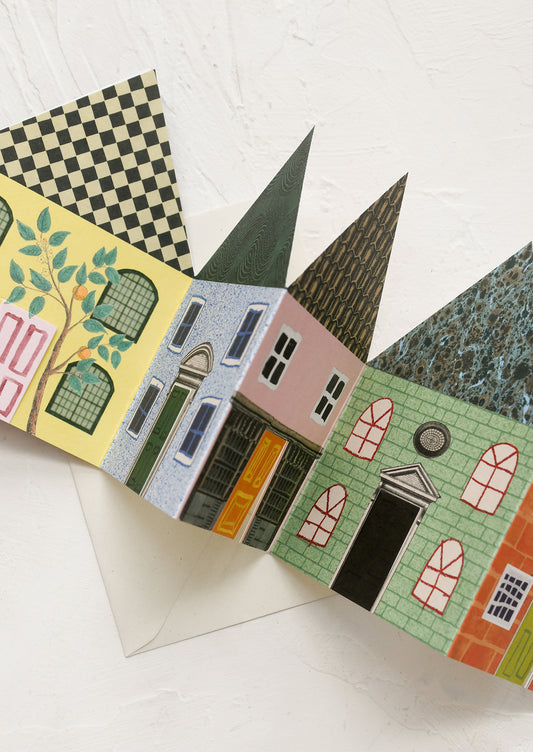 A colorful greeting card with house illustrations on a white background