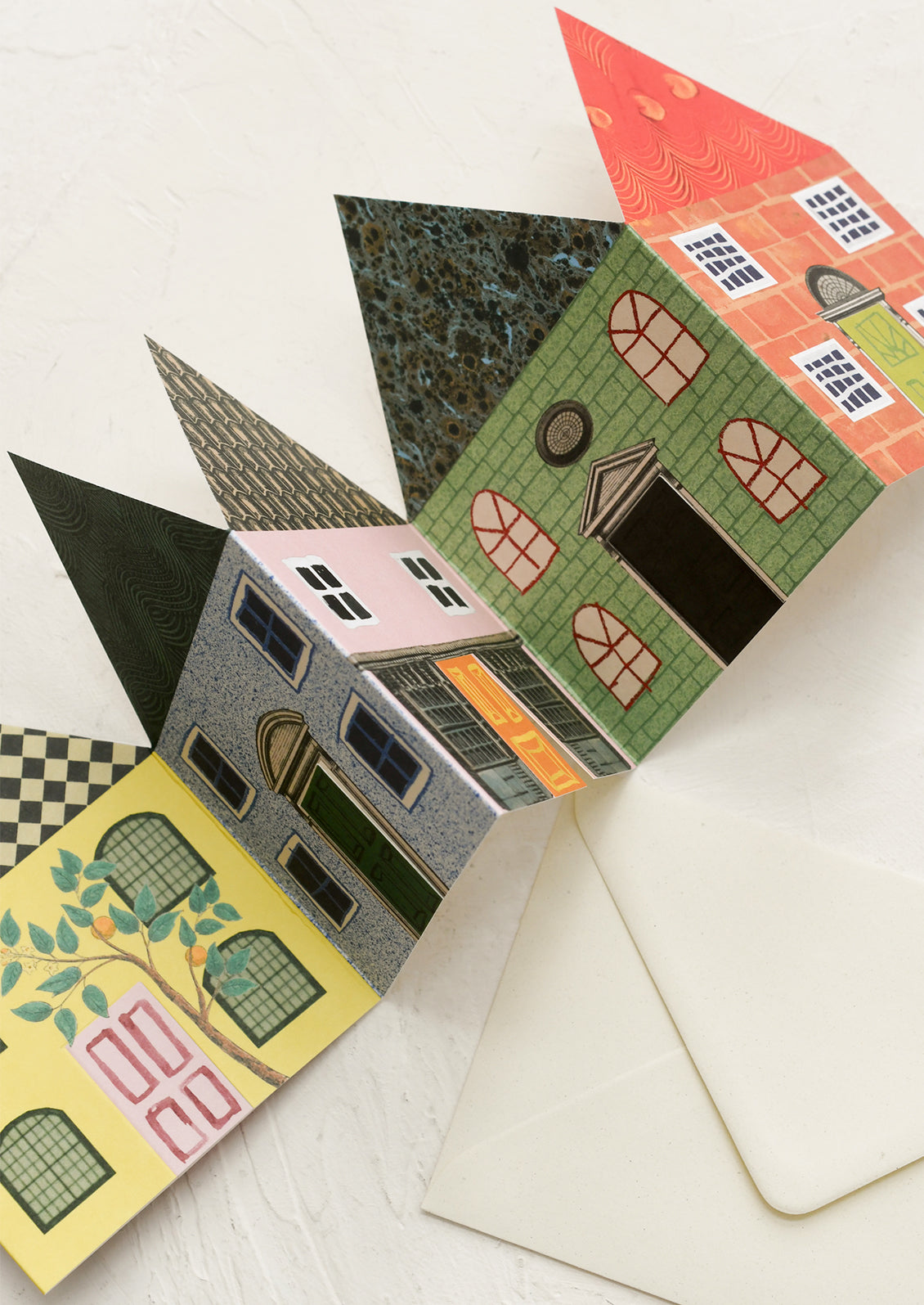 Colorful house-shaped card on a white surface