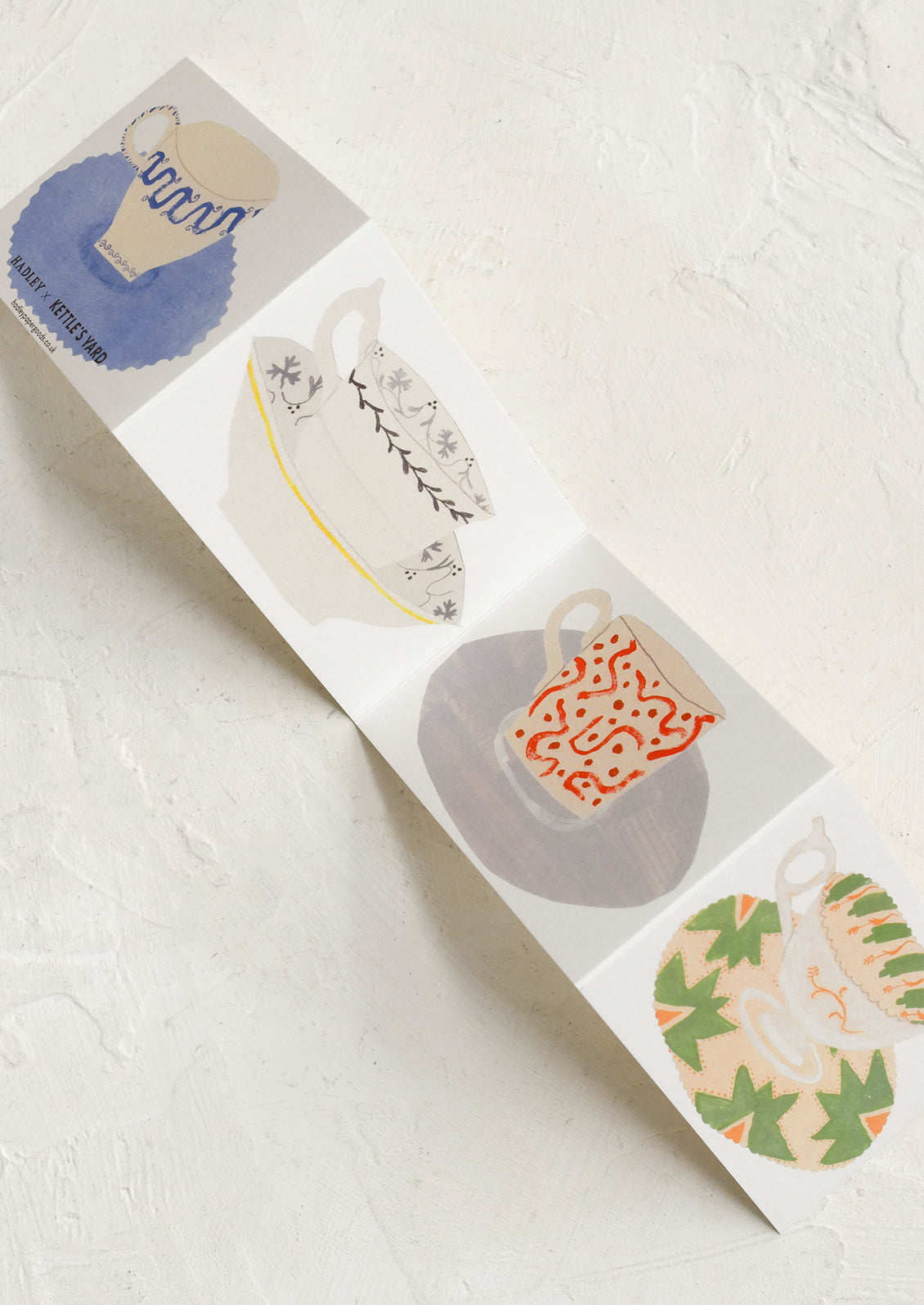 Set of ceramic mugs with various designs on a white surface