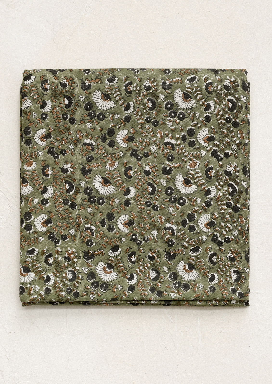Square fabric swatch with a detailed pattern on a beige background