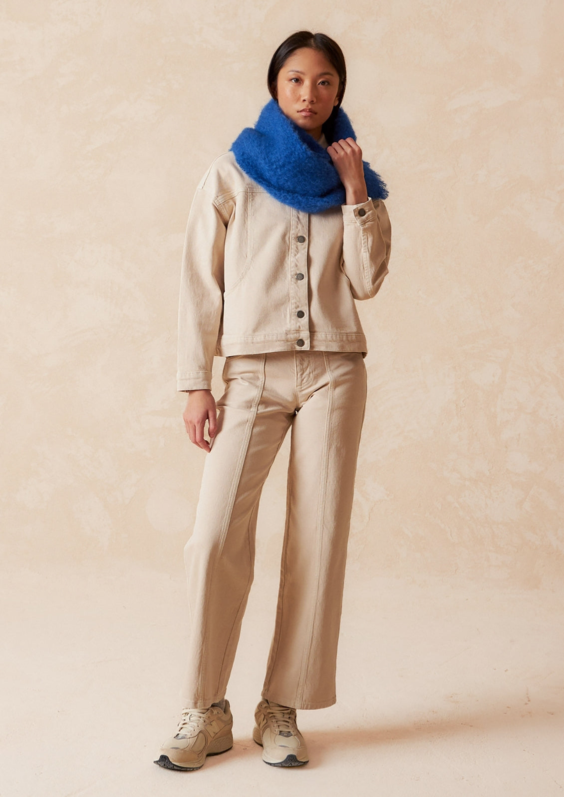 A pair of ecru wide leg jeans with vertical seam down front.