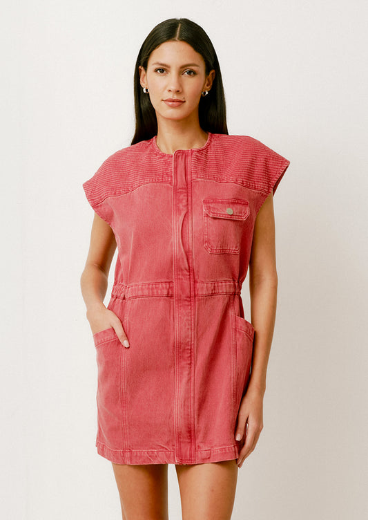 A person wearing a denim mini dress in red with cap sleeves and front pockets.