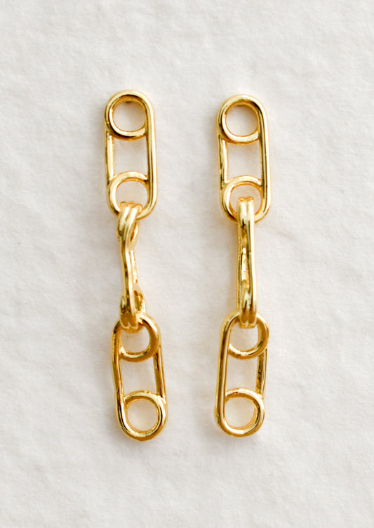 A pair of gold drop earrings with triple linked pin design.
