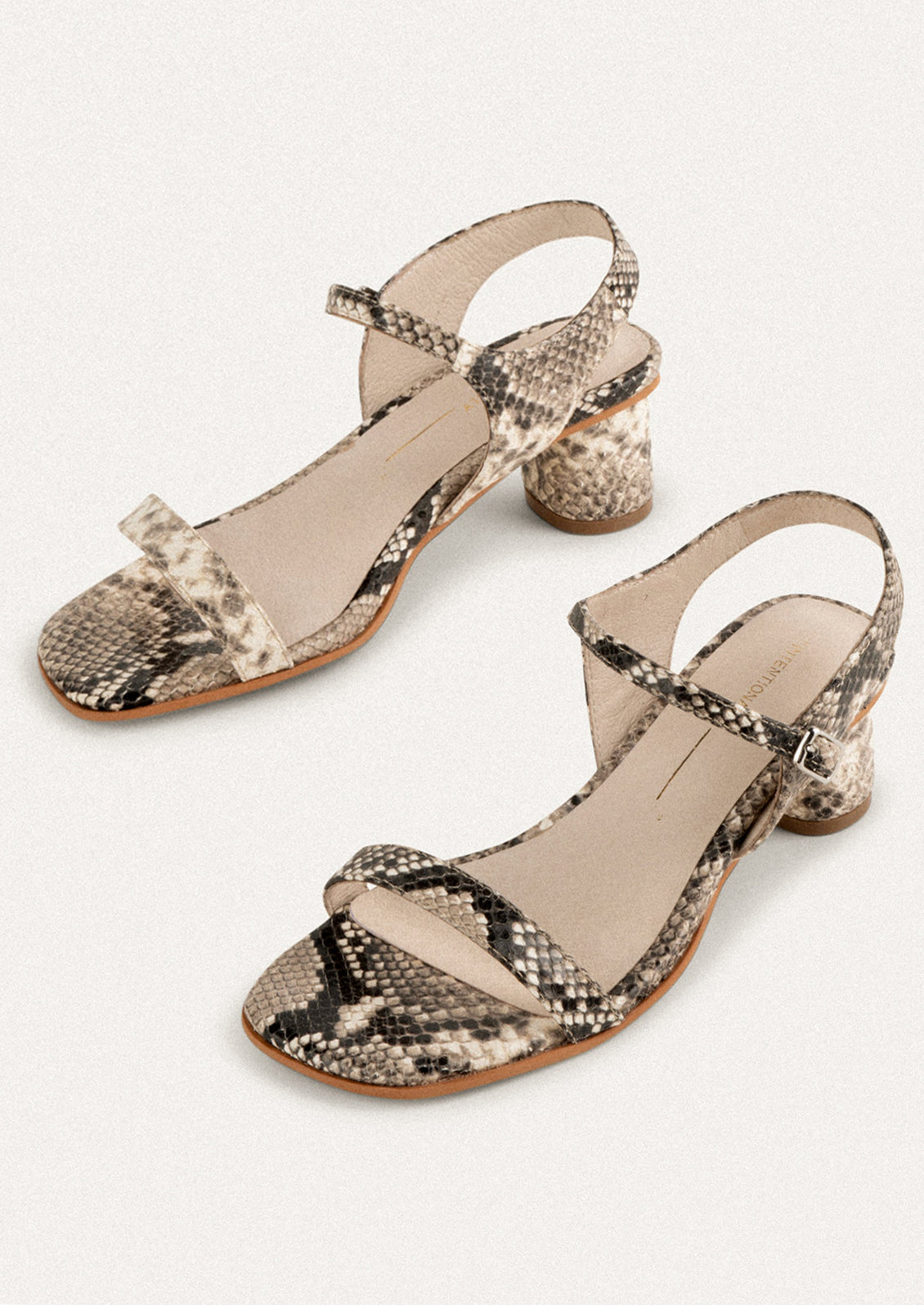 A pair of heeled leather sandals in lemon yellow.