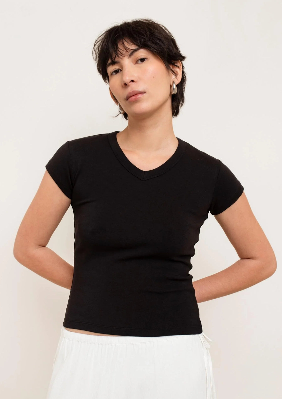 Woman wearing a black t-shirt against a white background