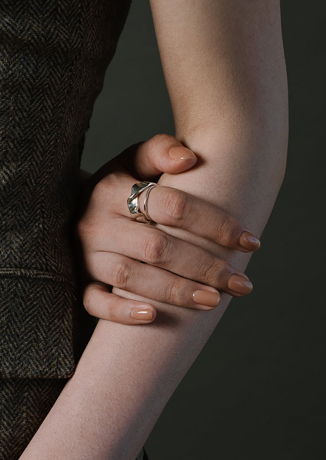 A sterling silver band ring in shape of fluid ribbon.