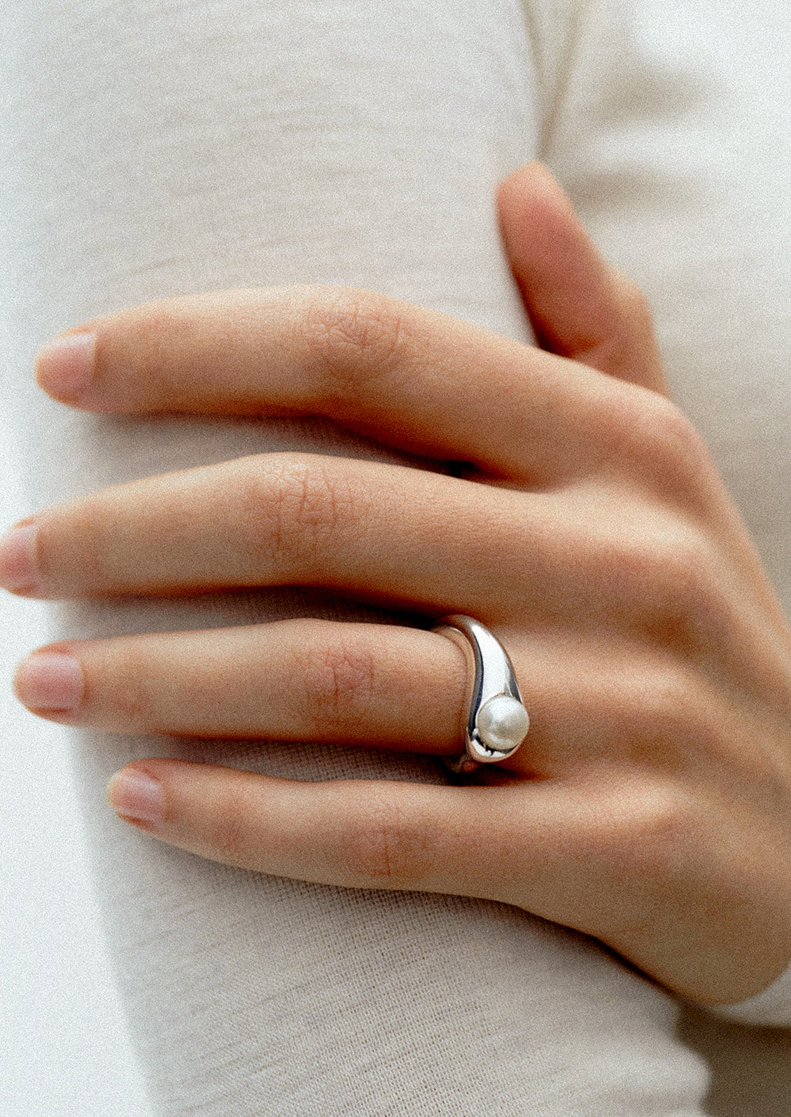 A high polish ring with pearl stone.