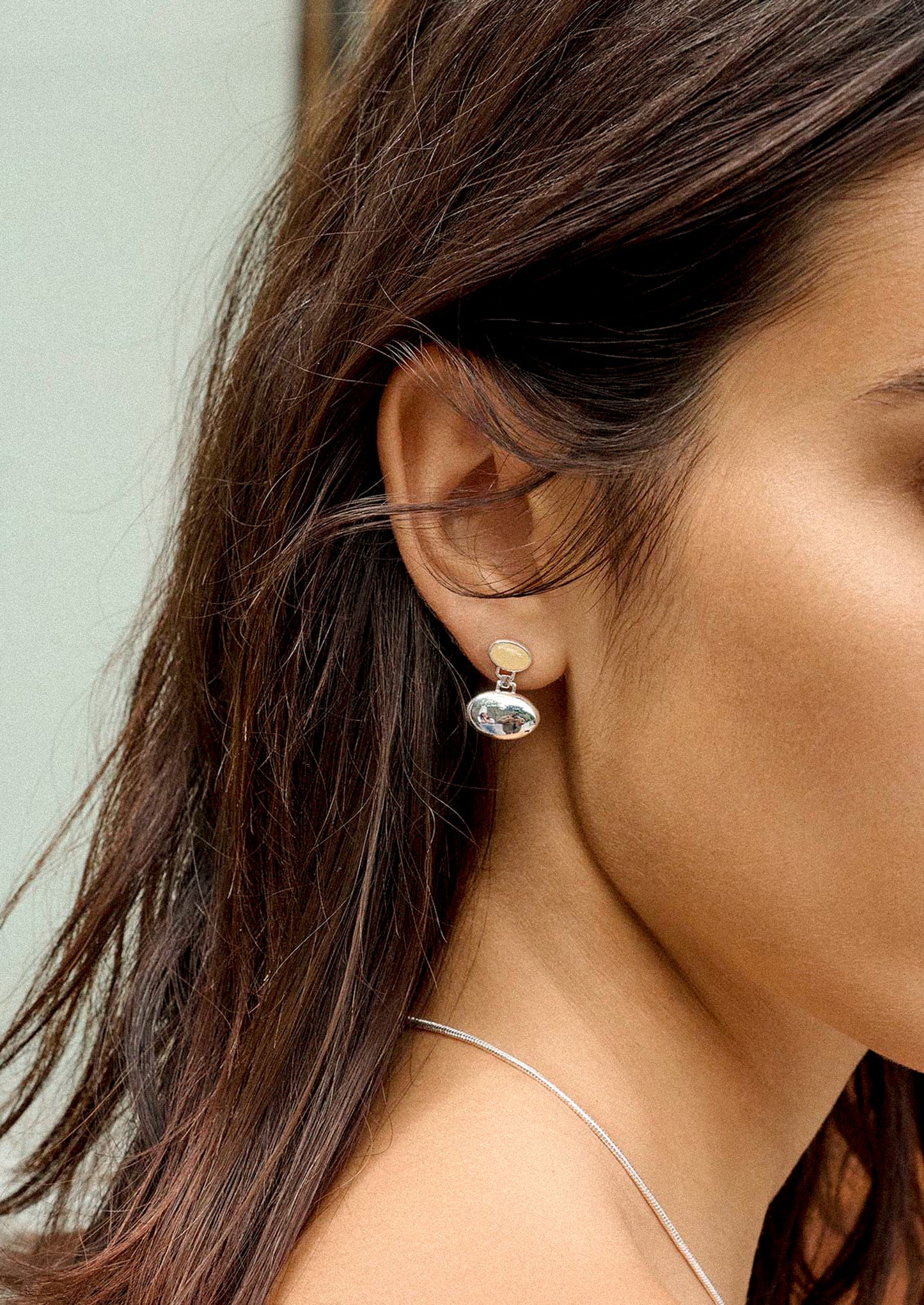 A pair of silver orb shaped earrings with honey topaz post.