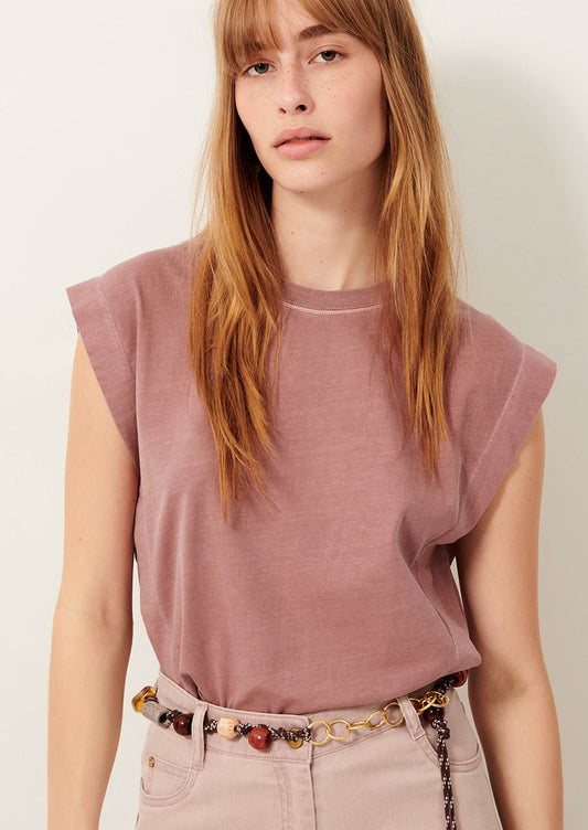 A person wearing a muscle tee in muted mauve color.