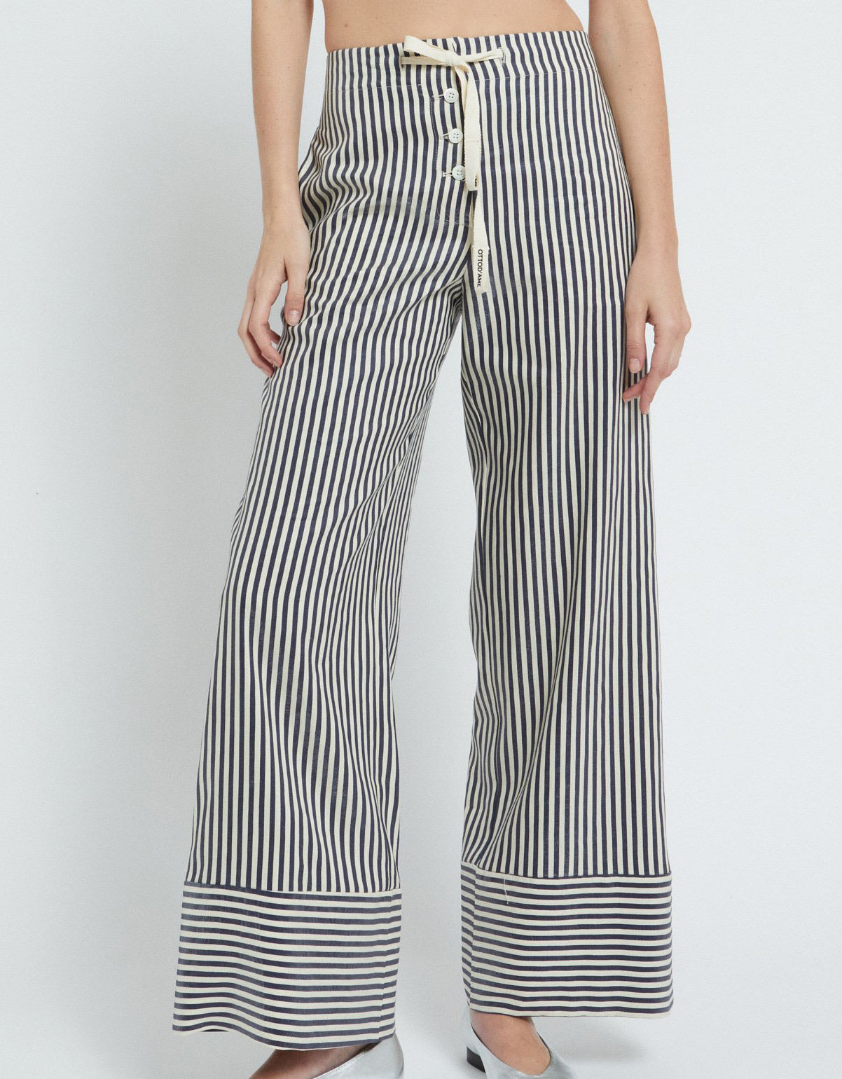 A woman wearing a pair of striped pants.