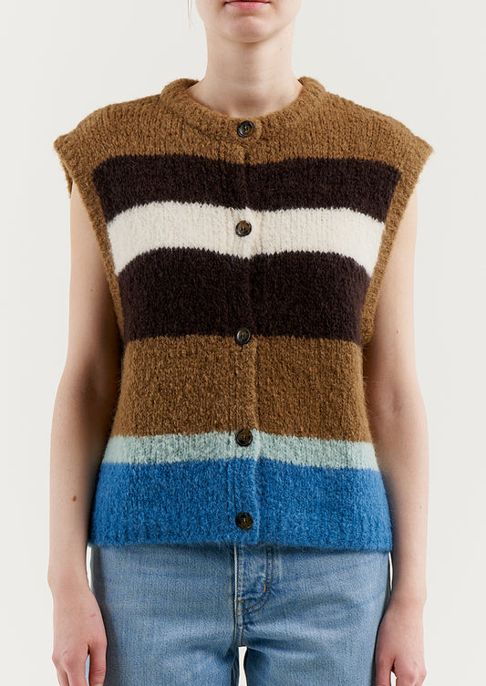 A woman wearing a sleeveless, button front sweater vest in brown and blue stripes.