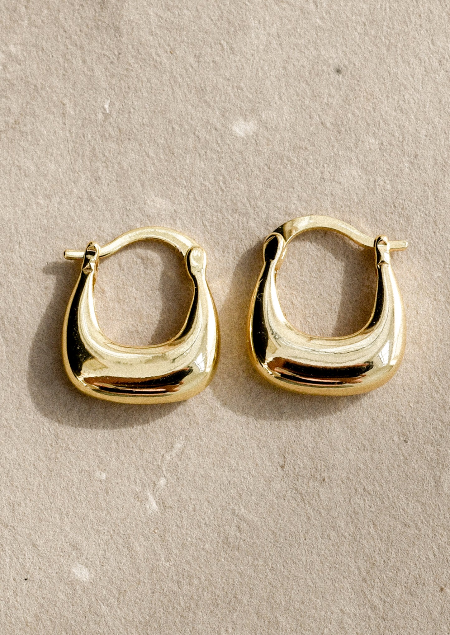 A pair of chunky squared oval hoop earrings.