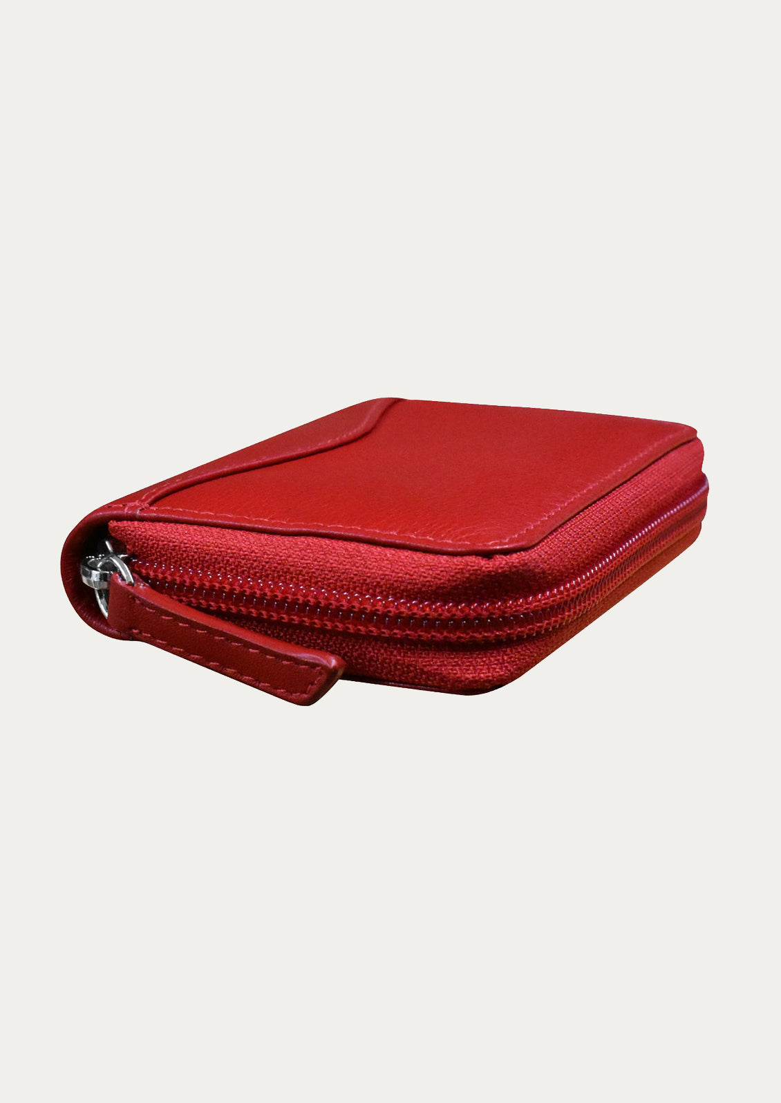 A leather card holder case in crimson.