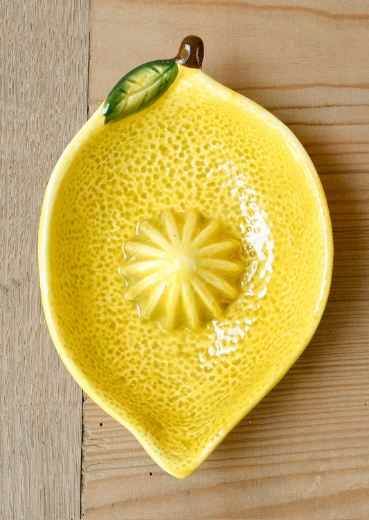 A ceramic citrus juicer in the shape of a lemon.