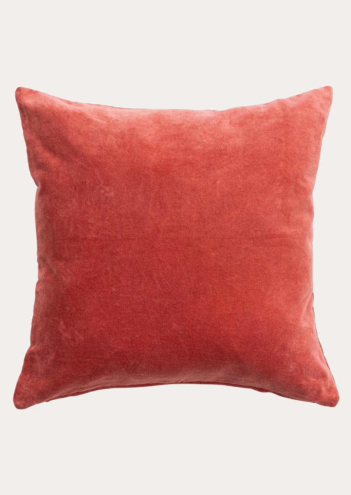 Red velvet cushion on a white background