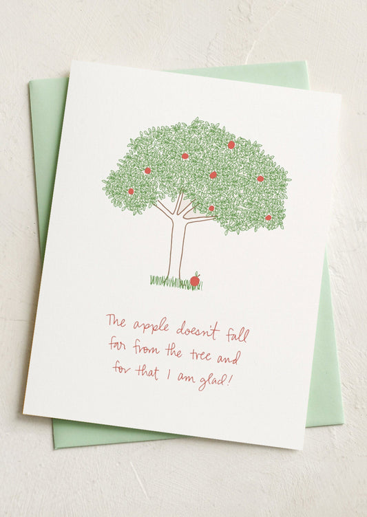 A card with image of an apple tree, text reads "The apple doesn't fall far from the tree and for that I am glad!".