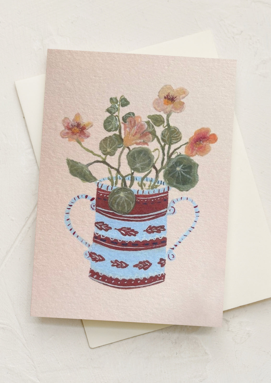 A mini greeting card in peach with illustration of nasturtiums in pot.