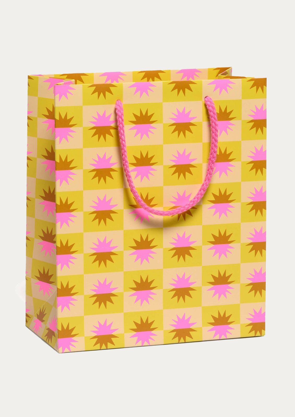 Gift bag with pink and brown pattern on a yellow background