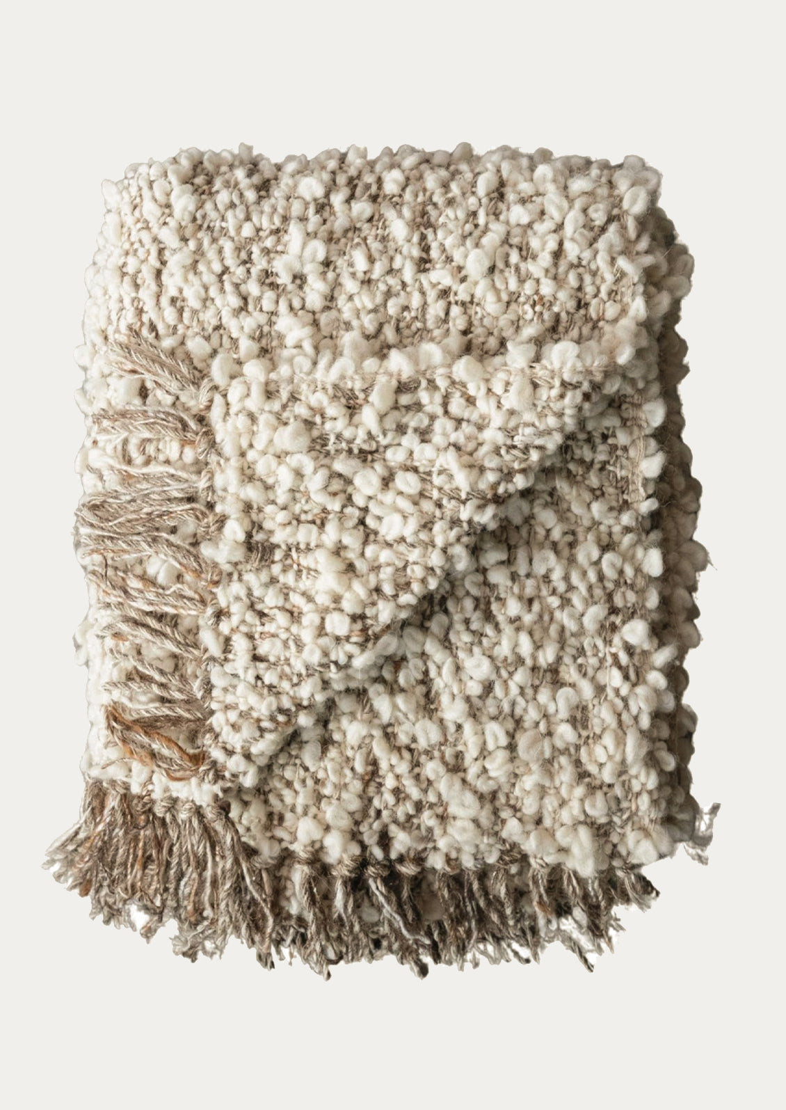 Textured throw blanket with fringe on a white background
