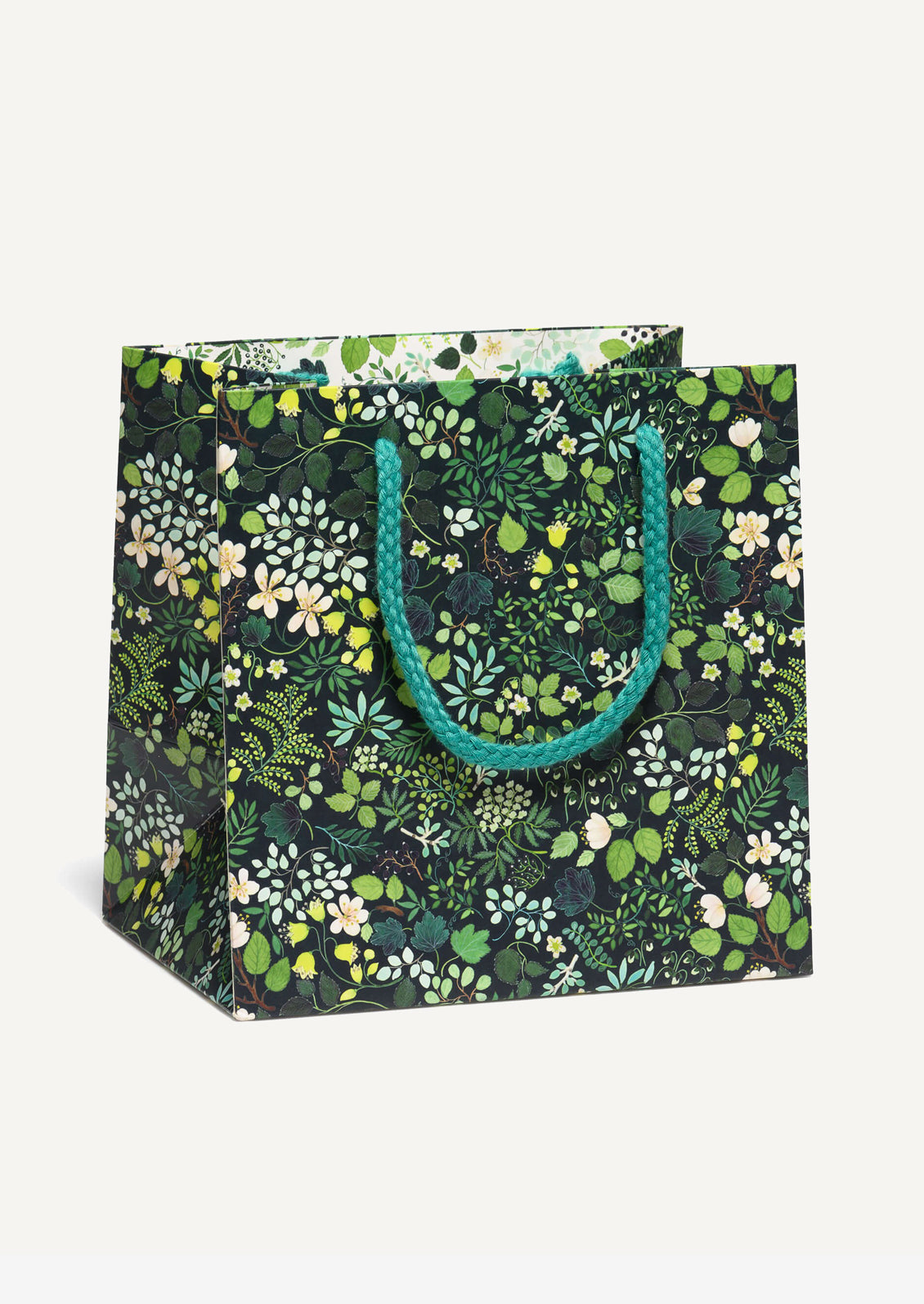 A small square shaped gift bag in green with floral leaf print.