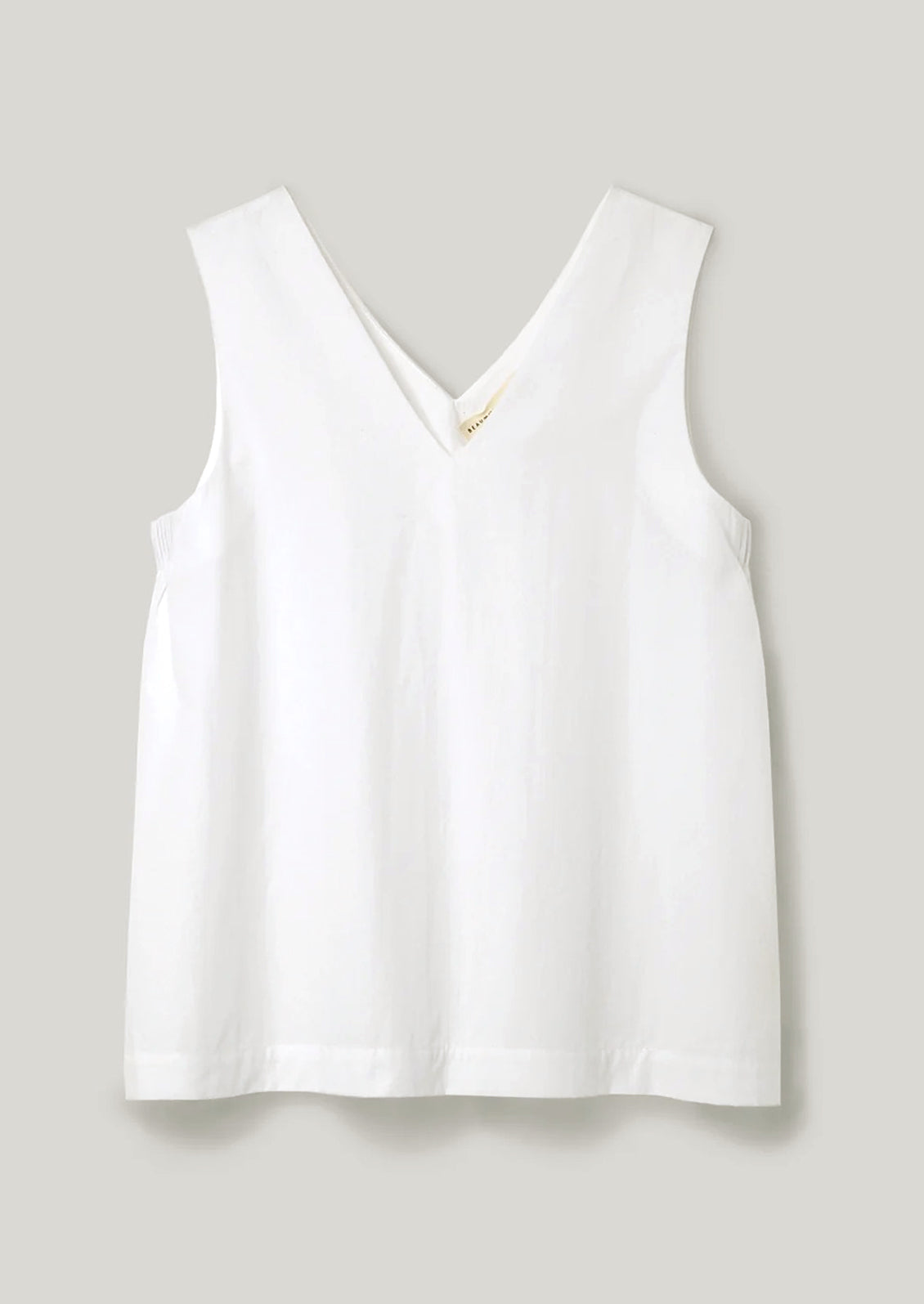 White sleeveless top on a light gray background