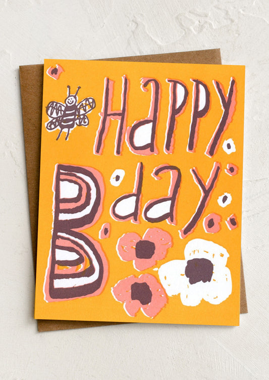 An orange greeting card reading "Happy B-day".