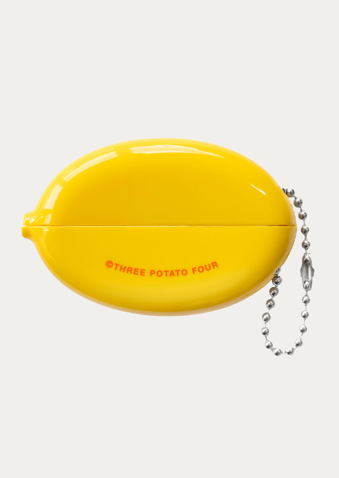 Yellow oval-shaped keychain with 'Three Potato Four' branding on a white background