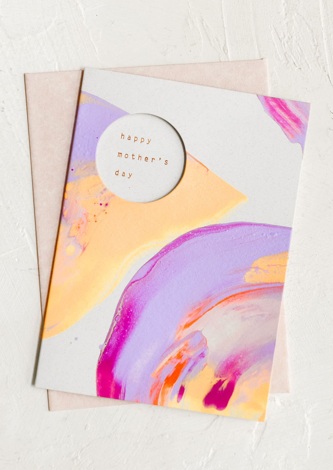 A neon painted card, circular cutout reveals inner text.