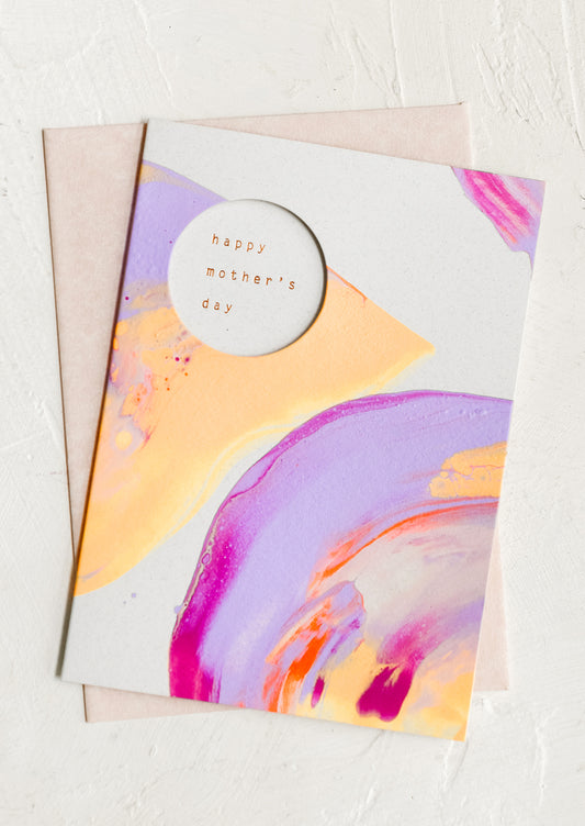 A neon painted card, circular cutout reveals inner text.