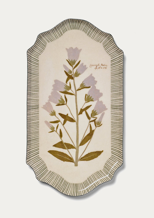 Decorative tray with floral design and textured border on a light background